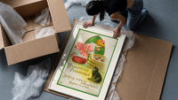 Girl bobbing for apples with cat framed print being unpacked from protective bubble wrap and a box