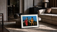 Witch and pumpkin man walking print in a slim black frame leaning on a travertine coffee table