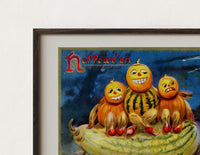 Close-up of the Anthropomorphic pumpkin heads and black cat print's dark wood frame corner and archival matte paper