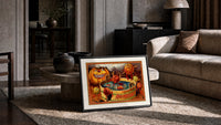 Anthropomorphic apples bobbing in tub print in a slim black frame leaning on a travertine coffee table