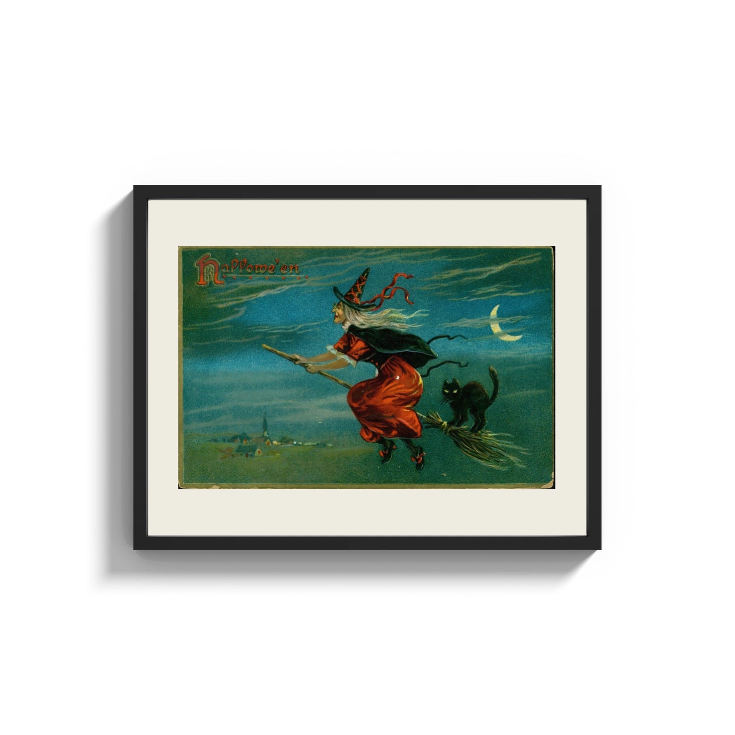 Framed Witch flying on broom with black cat print shown as a wide statement piece on a clean white wall