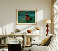 Witch flying on broom with black cat print in an oak frame above a mid-century book console with a vintage radio