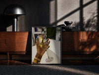 Black-framed Raised Wine Glass print on the floor in front of a dark wooden console