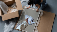 White Sneaker with Gold Chains framed print being unpacked from protective bubble wrap and a box