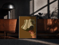 Black-framed Hand Holding Fanned Cash print on the floor in front of a dark wooden console