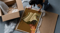 Hand Holding Fanned Cash framed print being unpacked from protective bubble wrap and a box