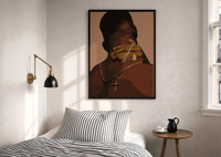 Hand Holding Layered Chains print in a black frame above a bed with striped linens, a brass wall lamp and a sunlit window