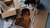 Hand Holding Layered Chains framed print being unpacked from protective bubble wrap and a box
