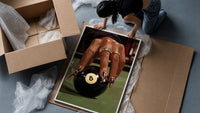 Hand on the Eight Ball framed print being unpacked from protective bubble wrap and a box