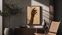 Hand with a Cross and Gold Chains poster framed above a fluted sideboard beside a potted tree