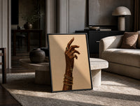 Hand with a Cross and Gold Chains print on the floor, leaning against a travertine table