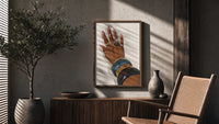 Hand with Blue Bangles poster framed above a fluted sideboard beside a potted tree