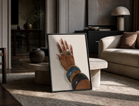 Hand with Blue Bangles print on the floor, leaning against a travertine table
