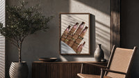 Hand with Brown Swirl Nails poster framed above a fluted sideboard beside a potted tree