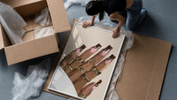Hand with Brown Swirl Nails framed print being unpacked from protective bubble wrap and a box