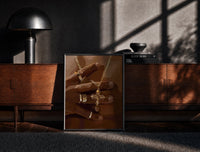 Black-framed Gold Cross Necklace print on the floor in front of a dark wooden console