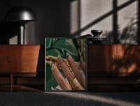 Black-framed Green French Tips print on the floor in front of a dark wooden console