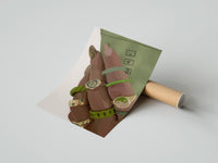 Gently curled Hand with Green Nails and Rings print beside its protective shipping tube