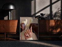 Black-framed Heart Nail Designs print on the floor in front of a dark wooden console