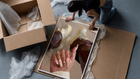 Heart Nail Designs framed print being unpacked from protective bubble wrap and a box