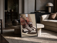 Hands Lacing Brown High-Tops print on the floor, leaning against a travertine table