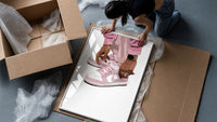 Pink Low-Tops framed print being unpacked from protective bubble wrap and a box