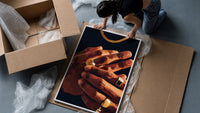 Hands with Gold Rings framed print being unpacked from protective bubble wrap and a box