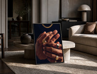 Hands with Gold Rings on Navy print on the floor, leaning against a travertine table