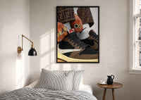 Hands with Rings and High-Top Sneakers print in a black frame above a bed with striped linens