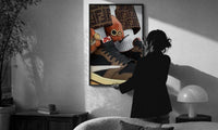 Hands with Rings and High-Top Sneakers print in a slim black frame being hung on a sunlit wall in a monochrome room