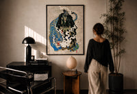 Hannya samurai and blue tiger print in a black frame on a sunlit plaster wall, a woman looking on beside a mushroom lamp