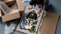 Hannya mask samurai beside a blue tiger framed print being unpacked from protective bubble wrap and a box