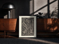Black-framed Nude witches with cauldron flying goat print on a moody console with designer coffee-table books