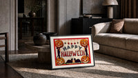 Halloween jack-o-lanterns and black cats print in a slim black frame leaning on a travertine coffee table