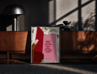 Black-framed Healing Is a Journey Book Page print on the floor in front of a dark wooden console