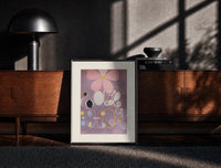 Black-framed Abstract flower with swirls and circles print on a moody console with designer coffee-table books