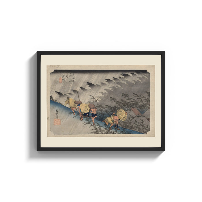 Framed Travelers in rainstorm on hillside path print shown as a wide statement piece on a clean white wall