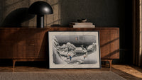 Snowy Japanese village travelers at night print in a black frame leaning against a walnut console in lamplight
