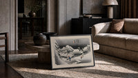 Snowy Japanese village travelers at night print in a slim black frame leaning on a travertine coffee table