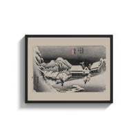 Framed Snowy Japanese village travelers at night print shown as a wide statement piece on a clean white wall