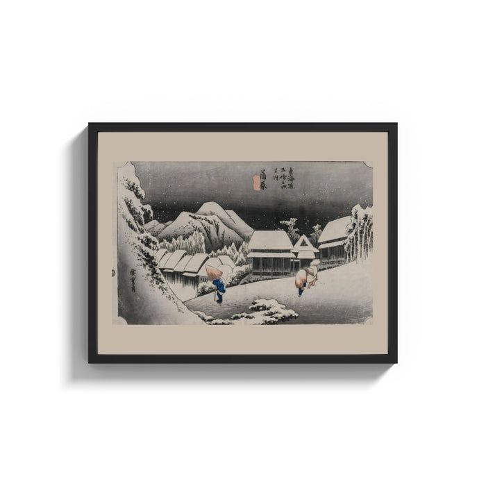 Framed Snowy Japanese village travelers at night print shown as a wide statement piece on a clean white wall