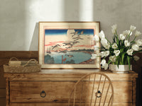 Flock of geese flying over bay print in an oak frame on a farmhouse dresser beside white tulips
