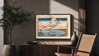 Flock of geese flying over bay print in a wood frame above a fluted sideboard beside an olive tree