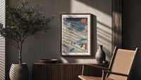 Snowy bridge with travelers in winter poster framed above a fluted sideboard beside an olive tree
