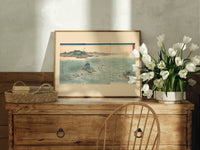 Japanese whirlpools and coastal seascape print in an oak frame on a farmhouse dresser beside white tulips