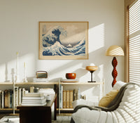 Great wave with boats and Mount Fuji print in an oak frame above a mid-century book console with a vintage radio