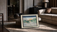 Mount Fuji reflected in water print in a slim black frame leaning on a travertine coffee table