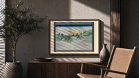 Mount Fuji reflected in water print in a wood frame above a fluted sideboard beside an olive tree