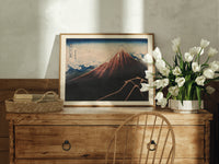 Mount Fuji with lightning storm print in an oak frame on a farmhouse dresser beside white tulips