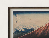 Close-up of the Mount Fuji with lightning storm print's dark wood frame corner and archival matte paper